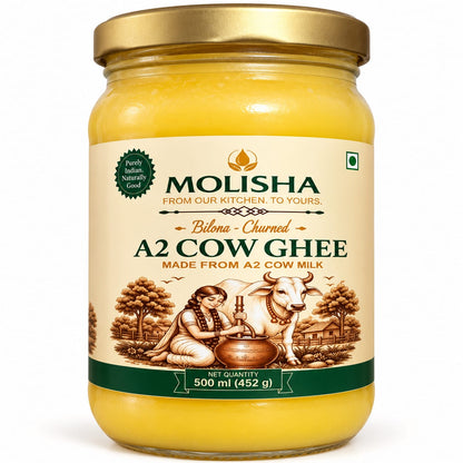 A 500 ml glass jar of Molisha Bilona Churned A2 Cow Ghee with a gold lid and cream-colored label, set against a plain white background.